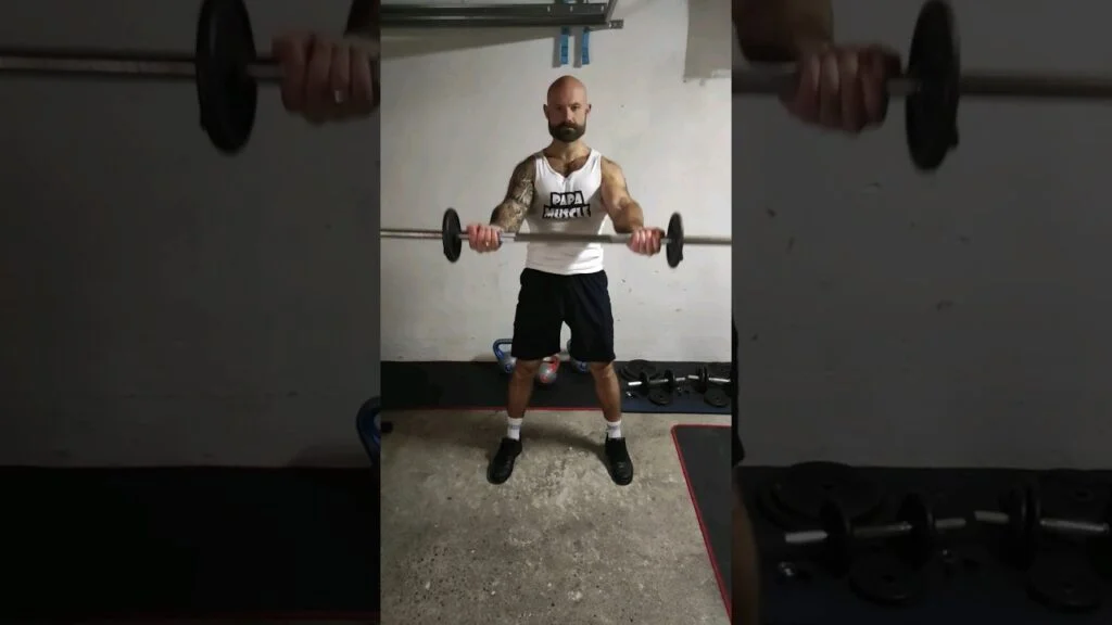 Élévation frontale debout barre supination (standing underhand barbell front raise)