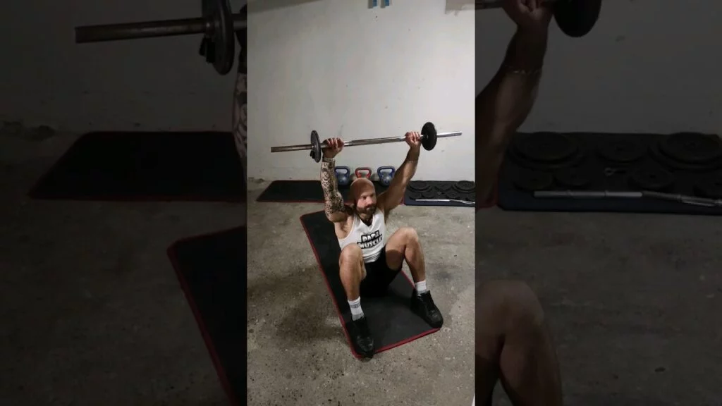 Sit-up au sol barre (barbell floor sit-up)